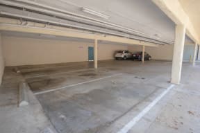 a parking garage with two cars in it