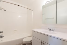 a bathroom with a sink toilet and a bath tub