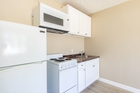 a kitchen with a stove microwave and refrigerator
