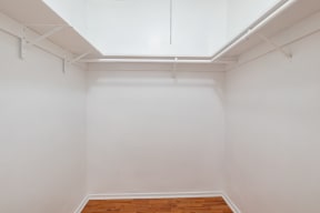 an empty room with white walls and a wood floor