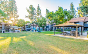 a park with picnic tables and buildings with trees at Metro 3610, California