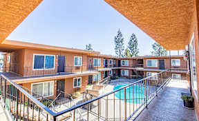 A view of a pool from a balcony of a building.