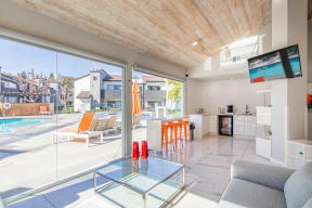 a living room with a glass table and a pool