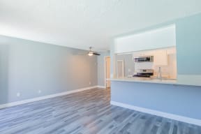 an open living room and kitchen with a counter top and