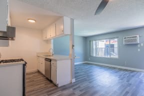 an empty kitchen and living room with a large window