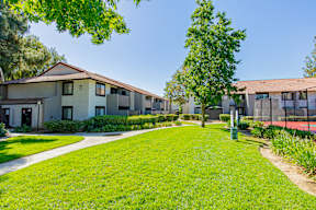 A green lawn leads to a building with a brown roof at Metro 3610, Riverside, 92505