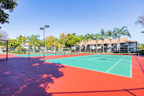 A tennis court with a red and green surface at Metro 3610, Riverside, 92505