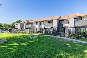 A row of houses with a green lawn in front at Metro 3610, Riverside, 92505