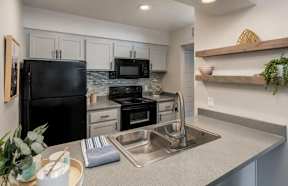 Kitchen with black appliances at Sofia Apartments, Tempe, 85283
