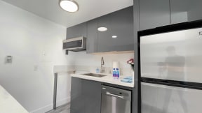 a kitchen with a sink and a refrigerator