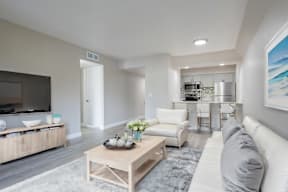 A modern living room with a white sofa and a wooden coffee table at Sofia Apartments, Tempe, 85283