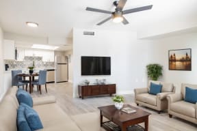 a living room with couches and a table with a tv