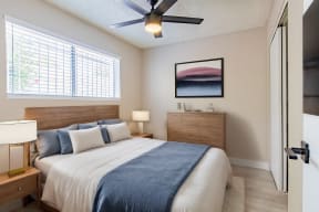 a bedroom with a large bed and a ceiling fan