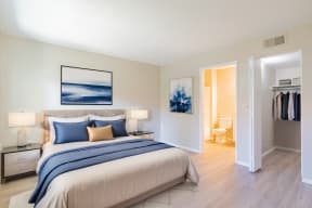 a bedroom with a bed and a closet and a bathroom
