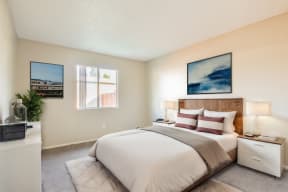 a bedroom with a bed and two windows