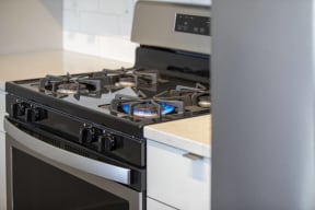a black and white kitchen with a stove top oven
