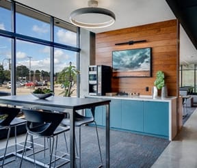 a kitchen with a table and chairs next to a window