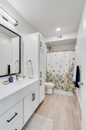 a bathroom with a toilet and a sink and a mirror