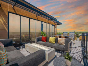 a living area with couches and a table with a fire pit