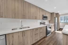 a kitchen with white countertops and wooden cabinets