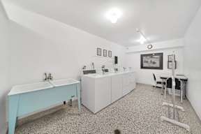 a laundry room with a sink and washer and dryer