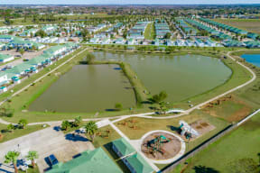Community aerial view of lake and playground