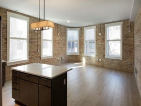 Historic corner apartment with exposed brick walls and large windows