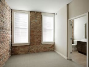 Bedroom with exposed brick wall