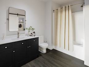 a bathroom with a toilet and a sink and a mirror