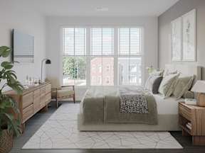 a bedroom with a bed and a large window