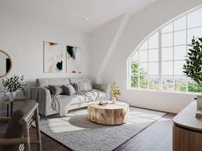 a living room with a couch and a round coffee table