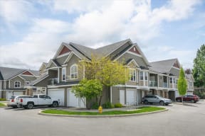 a large house with cars parked in front of it