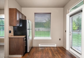 a kitchen with a refrigerator and a window