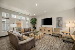 a living room with couches and chairs and a television