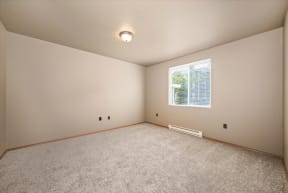 an empty room with carpet and a window