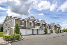 a row of houses with garage doors