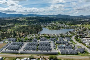 a city from the sky with houses and a lake
