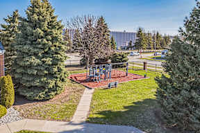 A park with a playground and trees.