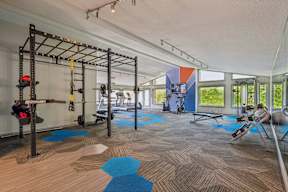 A gym with a pull up bar and weights.