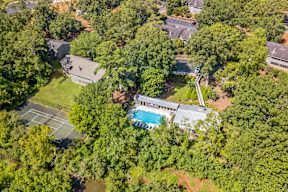 A bird's eye view of a house surrounded by trees.