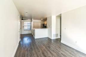 A room with wooden floors and white walls.