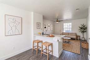 A kitchen with a bar stool and a countertop.
