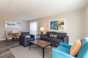 a living room with a couch and a chair and a table