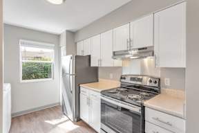 Renovated kitchen with white cabinets at Arbor Crossings Muskegon MI