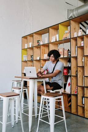 a man sitting at a table with a laptop