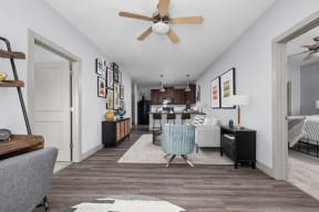 a living room and kitchen with a ceiling fan at the Vue apartments in Indianapolis