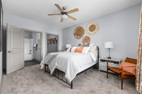 a bedroom with a bed and a ceiling fan