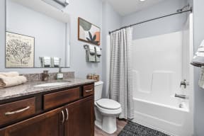 a bathroom with a shower and a sink and a toilet