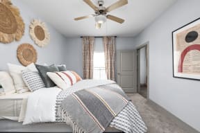 a bedroom with a bed and a ceiling fan