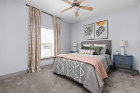 a bedroom with a bed and a ceiling fan at the Vue apartments in Indianapolis